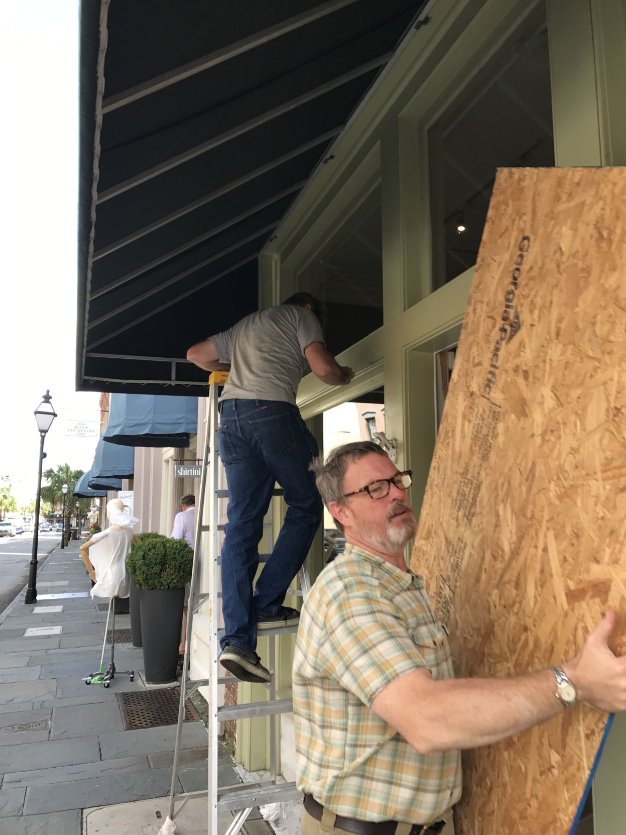 Audubon Gallery takes down plywood from windows after Hurricane Irma passes